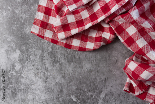 Red and white tablecloth on concrete table