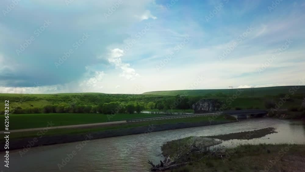Aerial Shot Of Pickup Truck Moving On Bridge Over River, Drone Flying Forward Over Water Against Sky - Billings, Montana Aerial Shot Of Pickup Truck Moving On Bridge Over River, Drone Flying Forward Over Water Against Sky - Billings, Montana