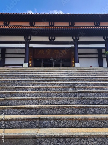 entrance to a Buddhist temple, with imposing gates and fascinating architectural details, conveying an atmosphere of serenity and spirituality. Zu lai temple photo