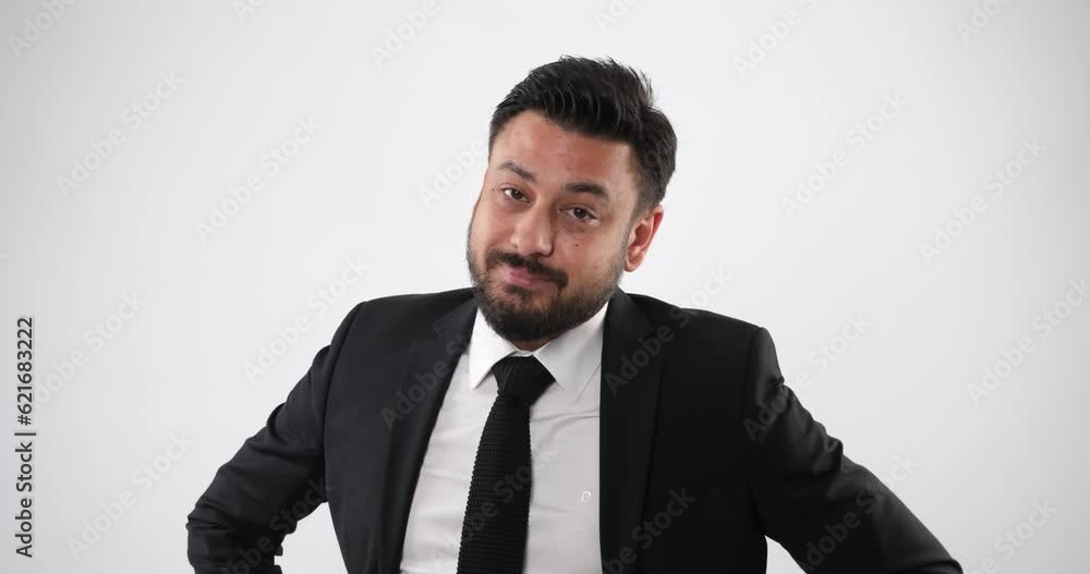 The businessman in a studio setting, through close-up shots, looks at the camera and makes gestures and facial expressions conveying phrases like 'We'll get back to you' or 'Call me.' The businessman in a studio setting, through close-up shots, looks at the camera and makes gestures and facial expressions conveying phrases like 'We'll get back to you' or 'Call me.'
