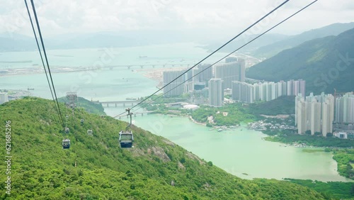 Landscape of Hong Kong cityscape skyline with skyscrapers building at downtown district and seascape from cable car riding to mountain peak in sunny day.