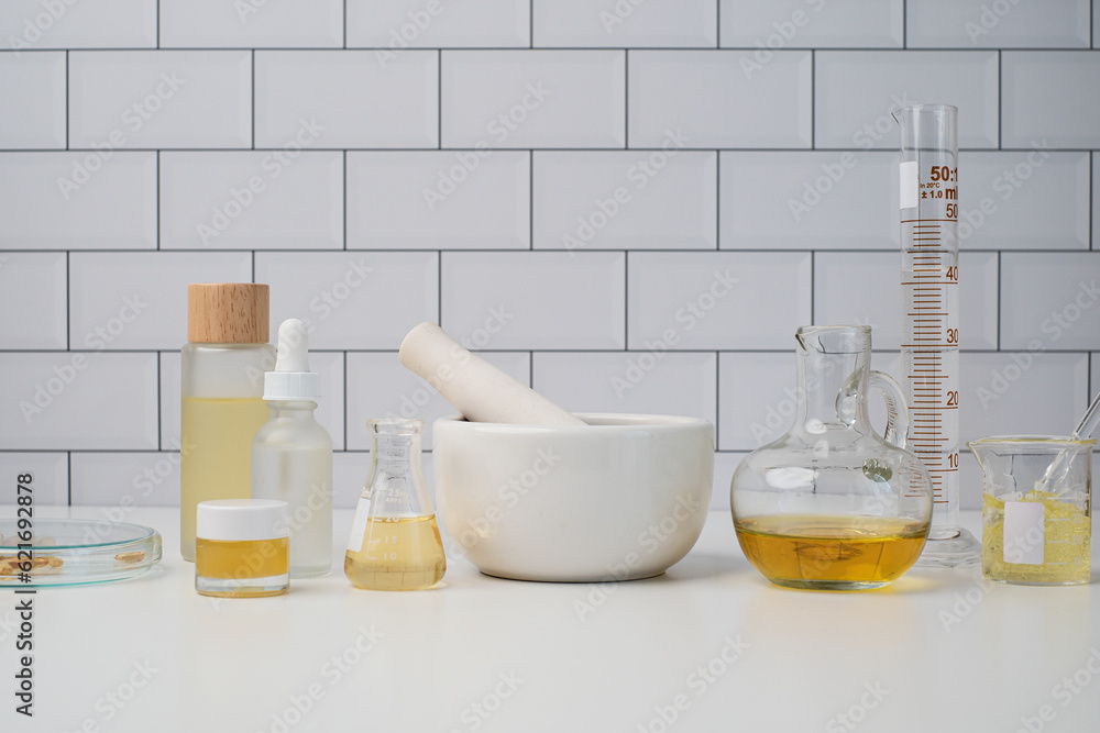 Cosmetic and skin care laboratory concepts with scientific equipment include cylinder, pesto, and mortar, beakers, and beauty product. Cosmetic and skin care laboratory concepts with scientific equipment include cylinder, pesto, and mortar, beakers, and beauty product.