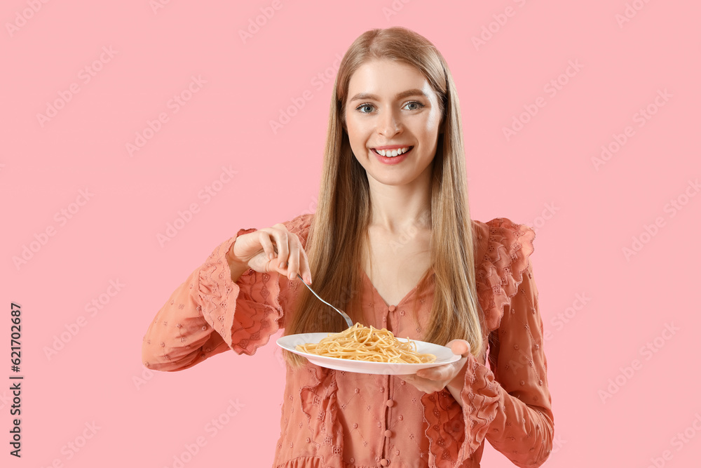 Young woman with tasty pasta on pink background Young woman with tasty pasta on pink background