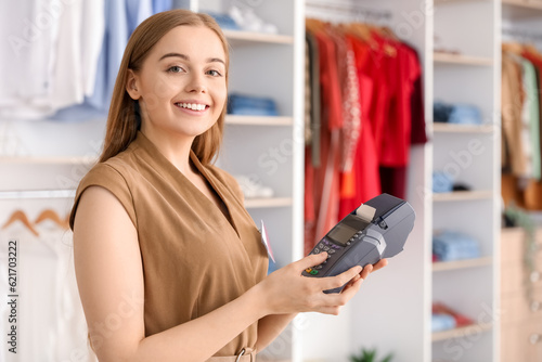 Female seller with payment terminal in boutique photo