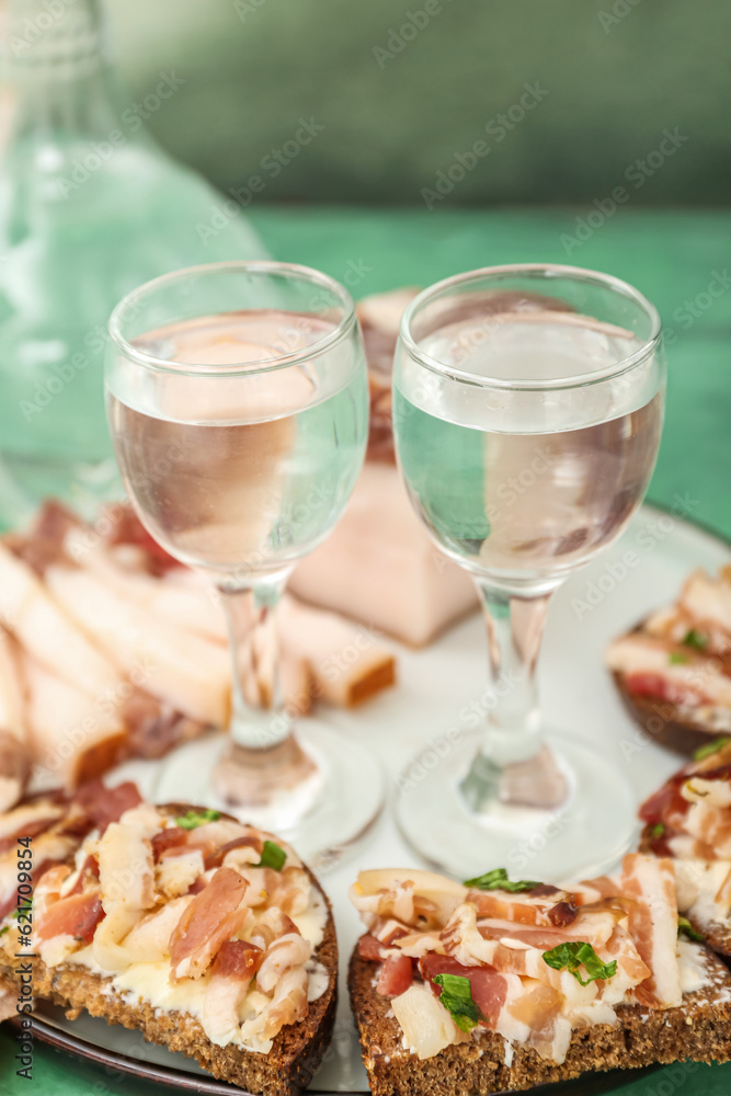 Shots with cold vodka and snacks on table Shots with cold vodka and snacks on table