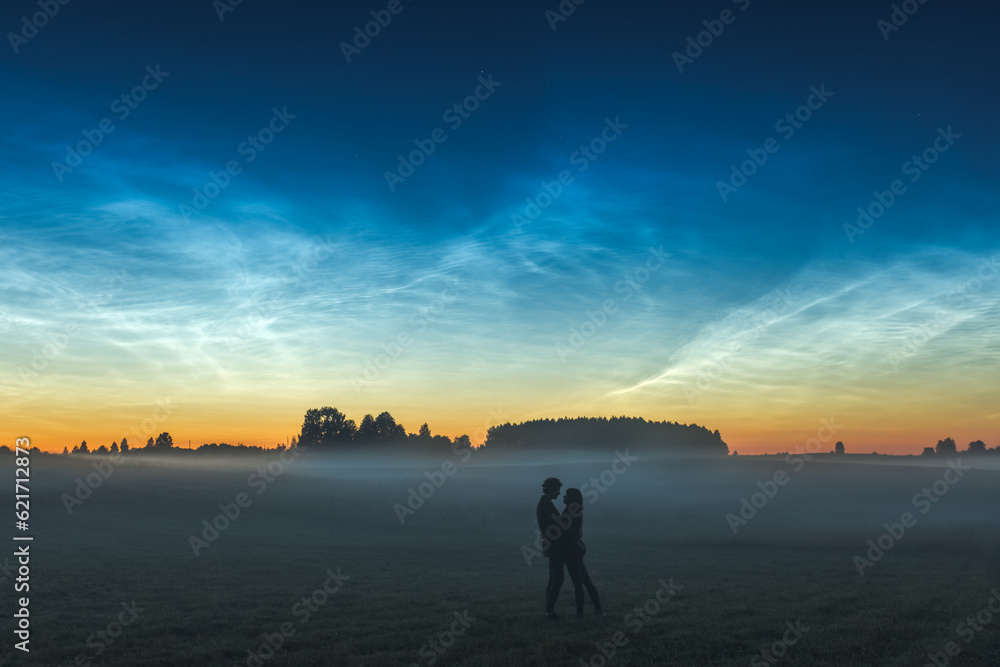 Couple dancing in the Night landscape with Noctilucent clouds at Lithuania