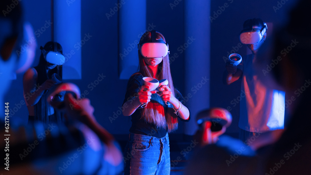 A team of young friends using virtual reality VR equipment on a arena