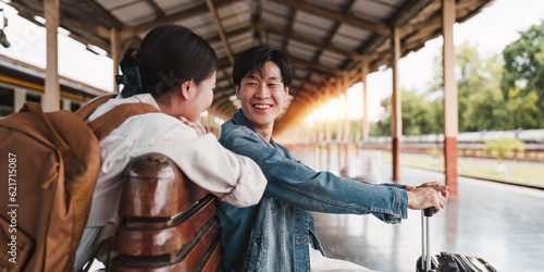 Asian couple at railway station have happy moment. Tourism and travel in the summer
