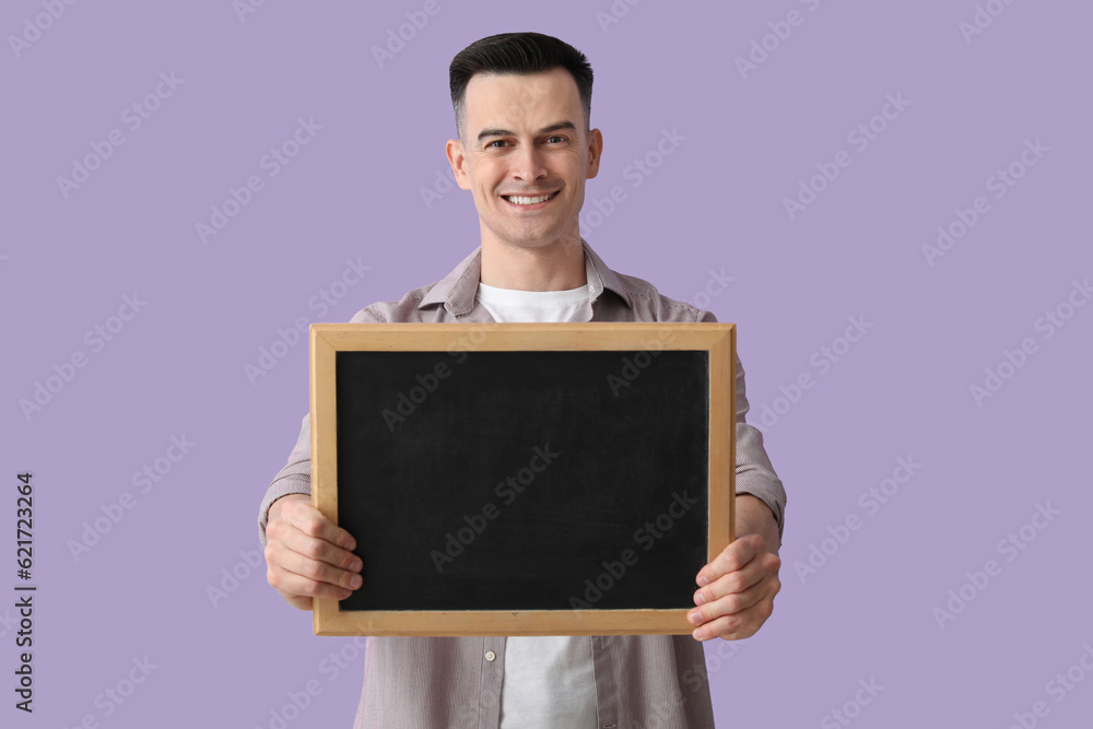 Male teacher with chalkboard on lilac background Male teacher with chalkboard on lilac background