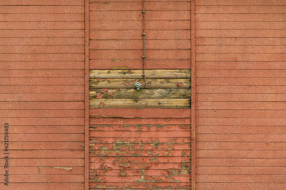 Old electrical light switch and cable on worn wooden shed exterior wall Old electrical light switch and cable on worn wooden shed exterior wall