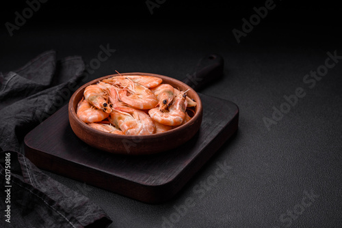 Delicious fresh boiled tiger prawns with salt and spices on a ceramic plate