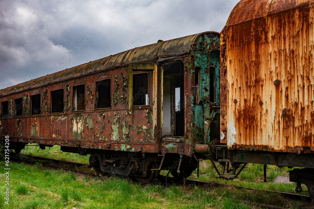 Old rusty passenger car abandoned on railway tracks Old rusty passenger car abandoned on railway tracks