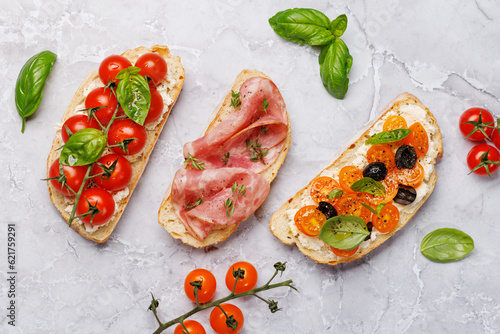 Sandwich set of bruschetta with juicy tomatoes, cheese and prosciutto