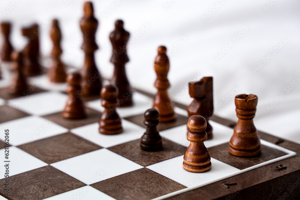 Chess pieces on game board in bedroom, closeup Chess pieces on game board in bedroom, closeup