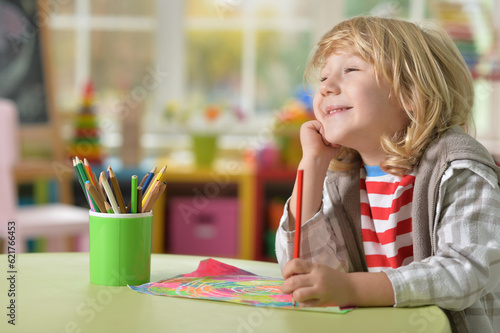 selective focus of kid drawing at desk