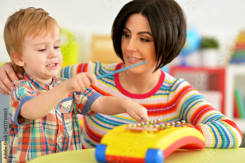 Young mother and cute little son playing
