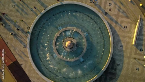 Air fountain from top to bottom 4k. People walk along the summer embankment.