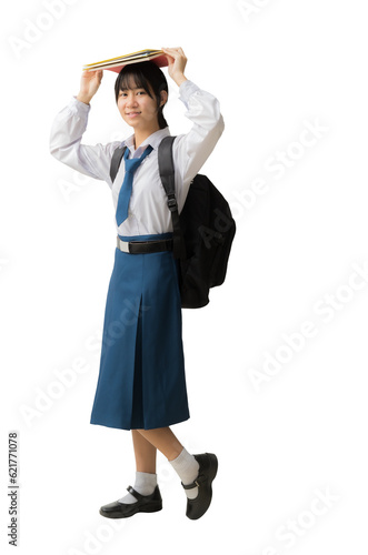Happy smiling Asian student girl wearing uniform holding books on head , isolated background