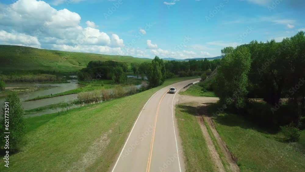 Aerial Forward Shot Of Pickup Truck Moving On Road Passing Through Field, Drone Moving Forward Over Landscape - Billings, Montana Aerial Forward Shot Of Pickup Truck Moving On Road Passing Through Field, Drone Moving Forward Over Landscape - Billings, Montana