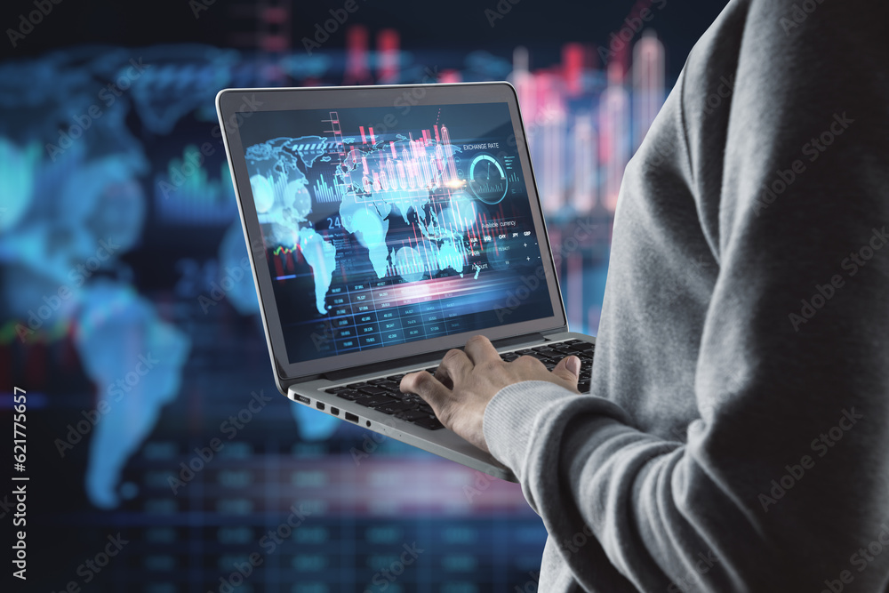 Fototapeta premium Close up of hacker hands using laptop with creative global forex chart on dark background. Concept of stock market, malware and financial success.
