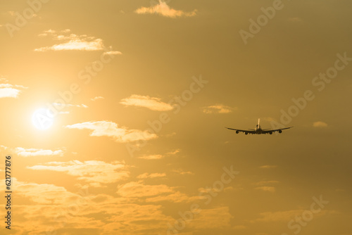 airplane in the sky at sunset