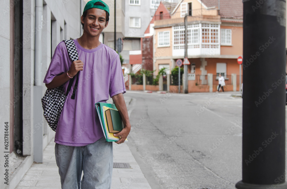 Fototapeta premium student with backpack and books on the street