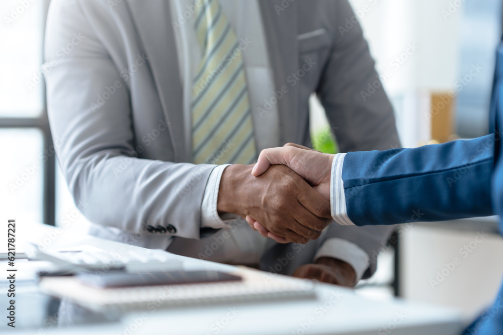 Business success. Business people handshake agreement confirmed in the investment business. Successful business people meeting together. Business success. Business people handshake agreement confirmed in the investment business. Successful business people meeting together.