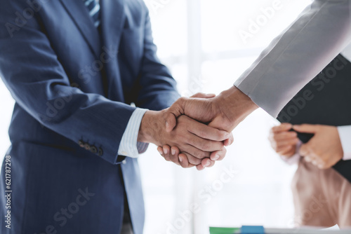 Business success. Business people handshake agreement confirmed in the investment business. Successful business people meeting together.