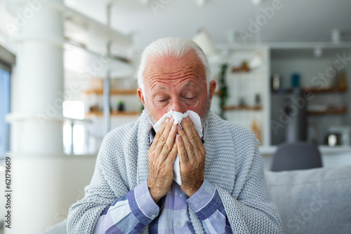 New coronavirus CoVid-19 outbreak situation with pandemic epidemic warning - adult caucasian senior old man with fever symptoms like illness cold seasonal influenza - people and virus concept