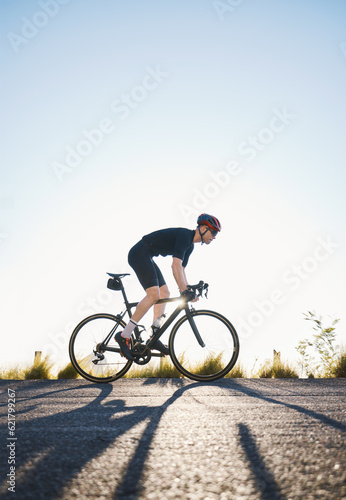 Mountain, fitness and man athlete on bicycle cycling training for a race or marathon in nature. Sports, workout and male cyclist riding a bike for cardio exercise on an outdoor off road trail.