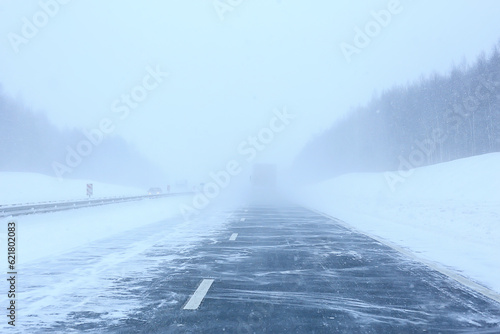 Canvas Print winter highway snowfall background fog poor visibility