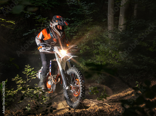 Motocyclist rides through the forest