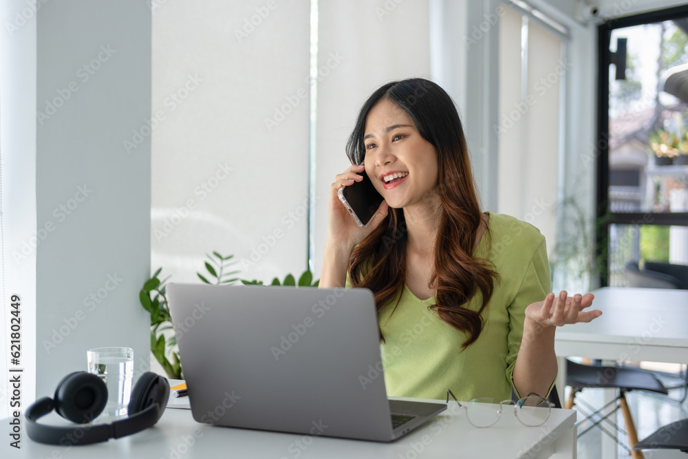 Young woman having phone call while online study. Young woman having phone call while online study.
