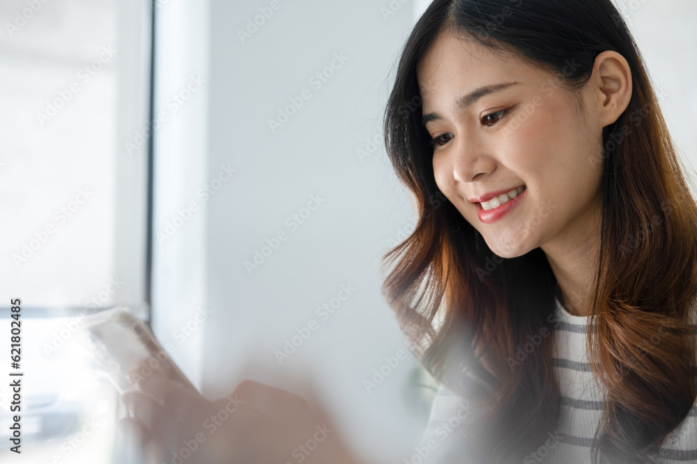 Young woman engaged in online study or project work with smartphone. Young woman engaged in online study or project work with smartphone.