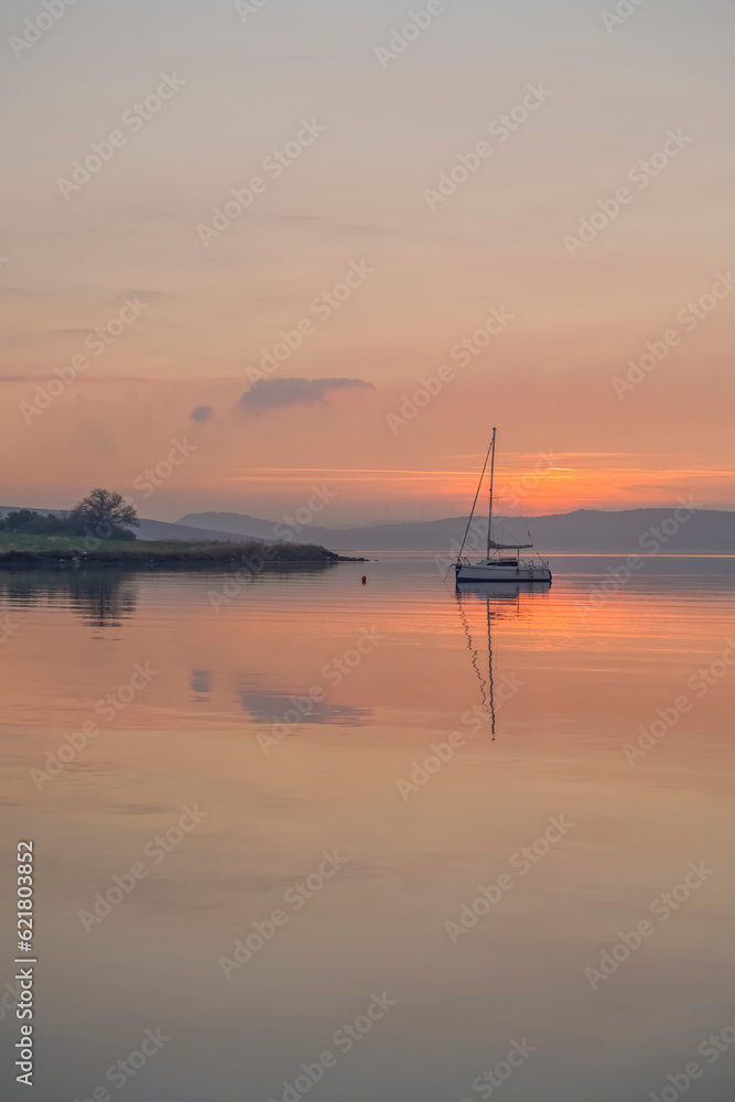 boats reflections and sky in still water at sunset boats reflections and sky in still water at sunset