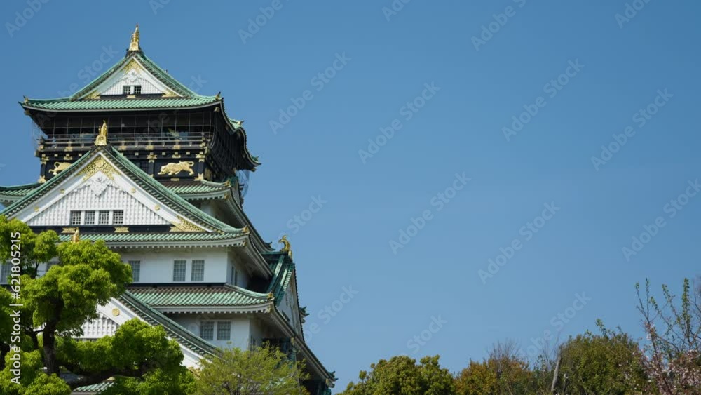 Slow panning shot of a traditional Japanese Temple in Osaka during summer Slow panning shot of a traditional Japanese Temple in Osaka during summer