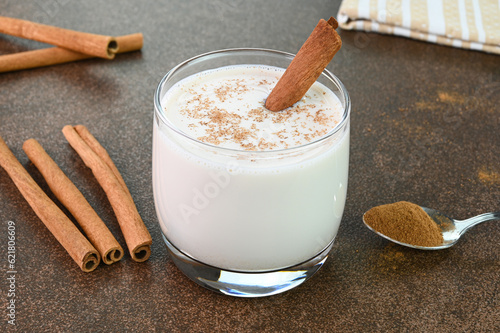 Cinnamon milk in a glass cup.