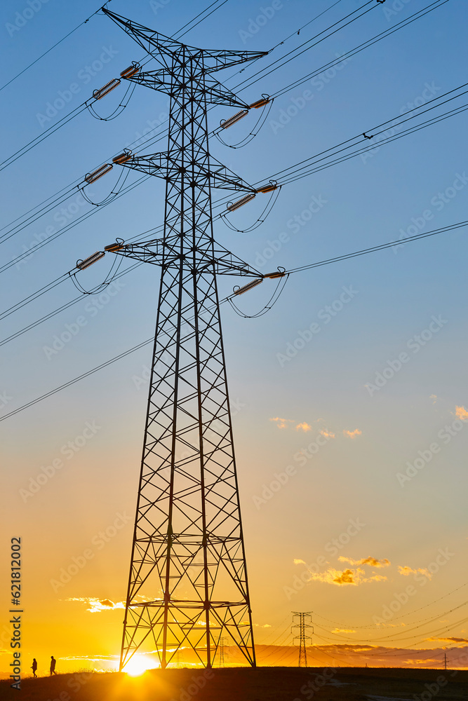 Power lines at sunset. Energy industry. Electricity distribution. Renewable production