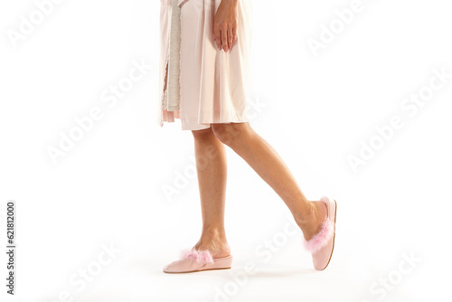 Female legs with hill shoes wearing a camisole. White background