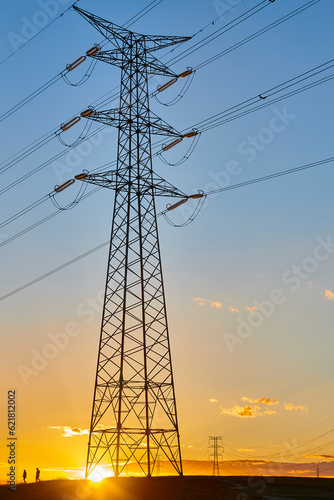 Obraz na płótnie Power lines at sunset. Energy industry. Electricity distribution. Renewable production w salonie