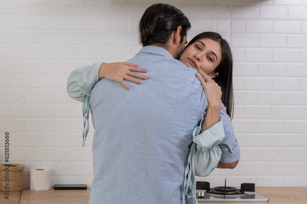 Obraz premium Young man making proposal give ring to surprise his girlfriend in kitchen