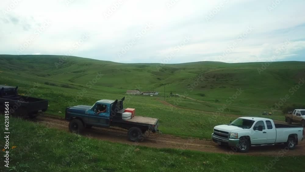 Aerial Panning Shot Of Pickup Trucks Moving On Dirt Road At Mountain, Drone Flying Over Landscape - Billings, Montana Aerial Panning Shot Of Pickup Trucks Moving On Dirt Road At Mountain, Drone Flying Over Landscape - Billings, Montana