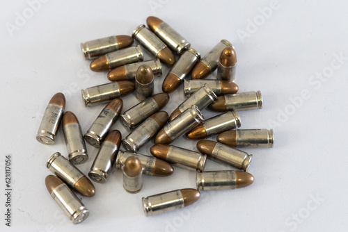 Wallpaper Mural Pile of golden 9mm pistol bullets on a white background
 Torontodigital.ca