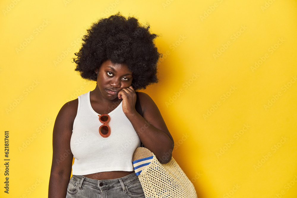 Beach-ready African-American woman, summer vacation vibe pointing temple with finger, thinking, focused on a task. Beach-ready African-American woman, summer vacation vibe pointing temple with finger, thinking, focused on a task.