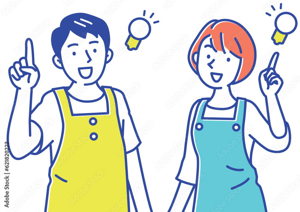 いいこと思いついたエプロンの若い保育士の男女 いいこと思いついたエプロンの若い保育士の男女