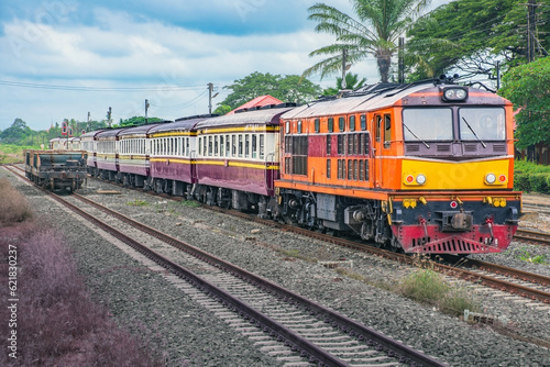 Passenger train by diesel locomotive on the railway. © siding_headtrack