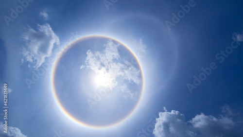 sun corona rainbow clouds and blue sky background   Circumscribed halo
