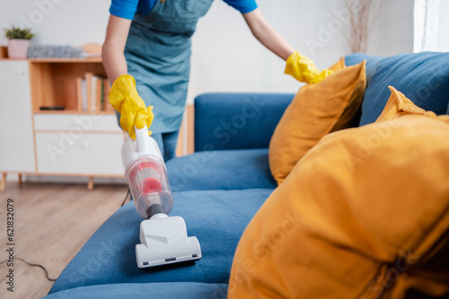 Housework or house keeping service female cleaning dust in home, cleaning agency small business. professional equipment cleaning old home.