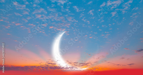 Ramadan Concept - Abstract background with Crescent moon over the sunset clouds © muratart