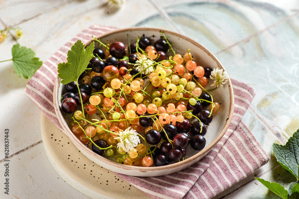yellow and black currants on a plate yellow and black currants on a plate